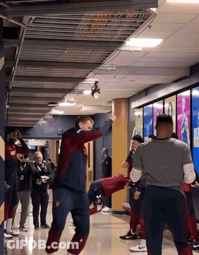 Group Standing In Hallway One In Nike Sweater GIF