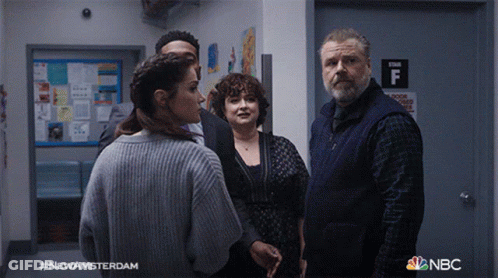 Group Standing In Hallway With Stair F Sign GIF