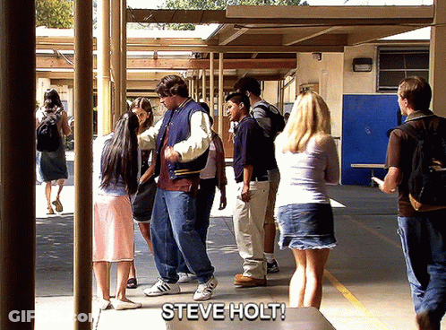Group Standing In Hallway With Steve Holt On Table GIF