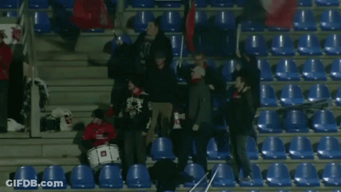 Group Standing In Stadium With Drummer Wearing Skulls Shirt GIF