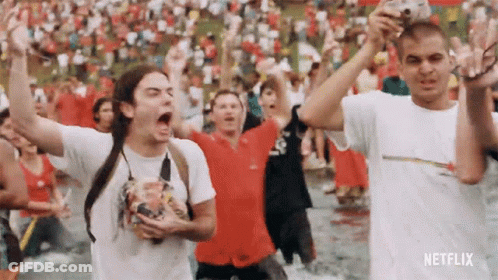 Group Standing In Water With Arms Up Netflix Logo GIF