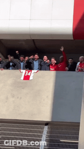 Group Standing On Balcony With 34 Shirt GIF