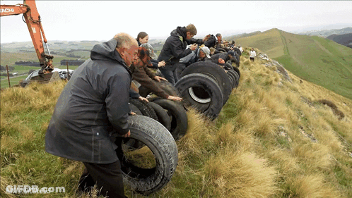 Group Standing On Hill With Hitachi Excavator GIF