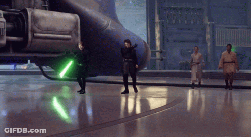 Group Standing With Green Lightsaber GIF
