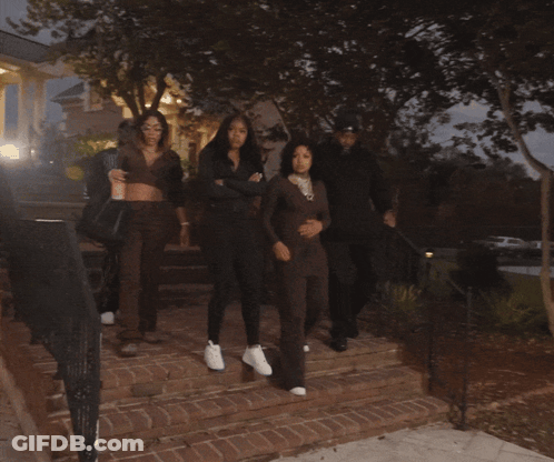 Group Walking Down Staircase In Dark Area GIF