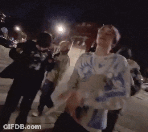Group Walking Down Street At Night GIF
