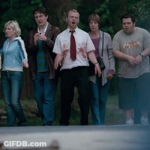 Group Walking Down Street, One Wearing I'm Very Wanted GIF