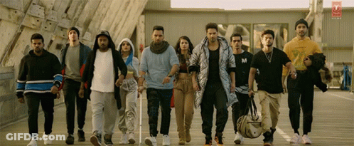 Group Walking Down Street One Wearing M Shirt GIF