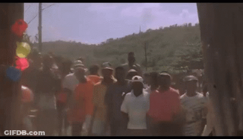 Group Walking Down Street With Balloons GIF