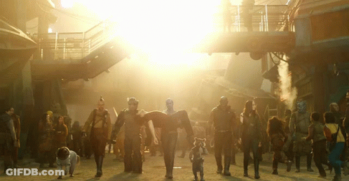 Group Walking Down Street With Bright Sun GIF