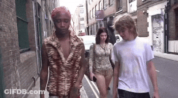 Group Walking Down Street With Man In Tiger Print Shirt GIF
