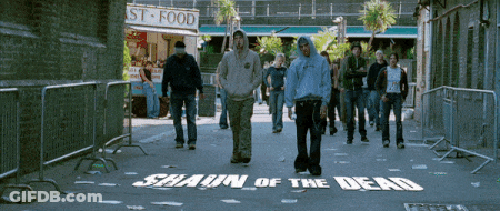 Group Walking Down Street With Shaun Of The Dead Painted On Ground GIF