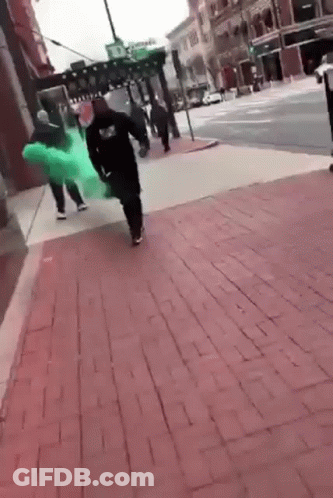 Group Walking On Brick Sidewalk With Green Dress GIF