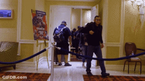 Group Walking Past Boxing Poster GIF