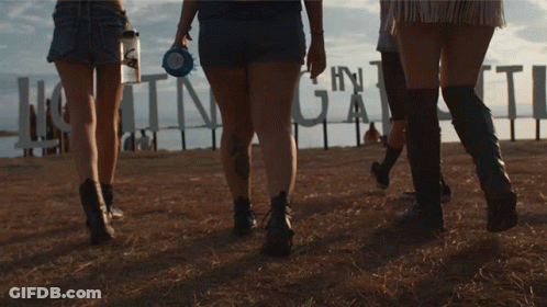 Group Walking Past Huntinggate Sign GIF