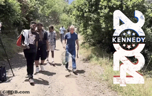 Group Walking Past Kennedy Poster GIF