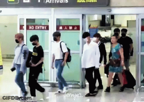 Group Walking Through Airport With No Entry Sign GIF