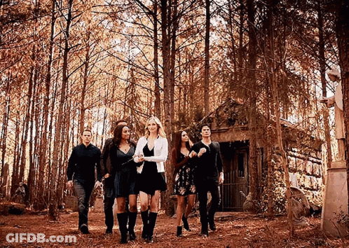 Group Walking Through Forest In Front Of House GIF