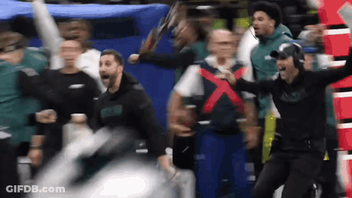Group Watching Football Game Man Holding Sign X GIF