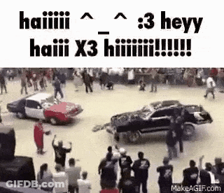 Group Watching Two Cars Crash At Race Track GIF