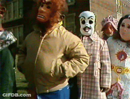 Group Wearing Masks In Front Of Gh-Zst Sign GIF