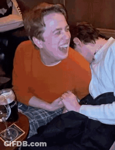 Guinness On Coaster Next To Two People GIF