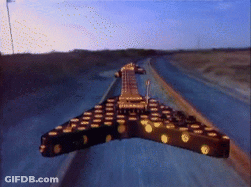 Guitar Driving Down Highway At Sunset GIF