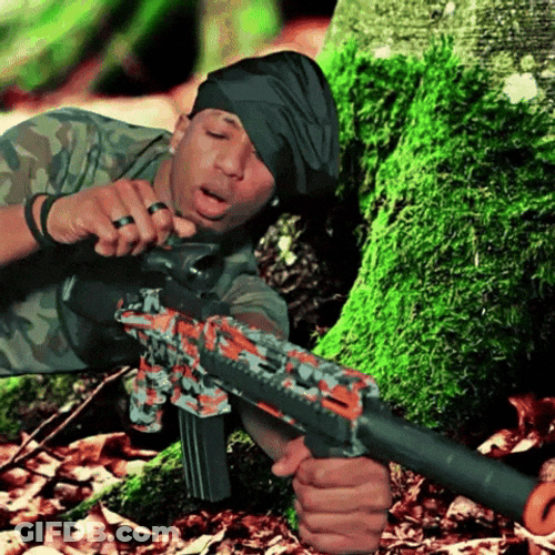 Gunner Lying Down Behind A Tree GIF