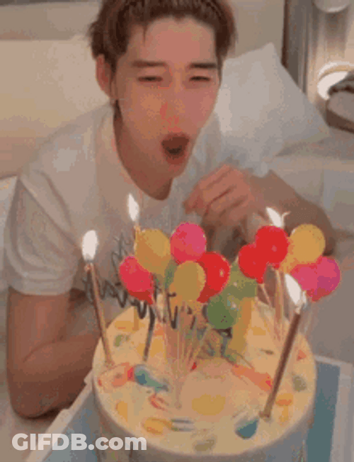 Guy Blowing Birthday Candles On Cake GIF