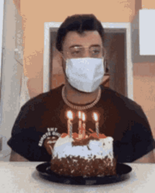 Guy Blowing Birthday Candles Using Hair Dryer GIF