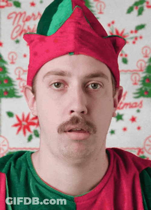 Guy Christmas Elf Spitting Gifts GIF
