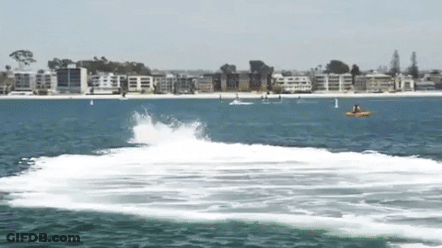 Guy Fly Boarding Near Parked Skiff GIF