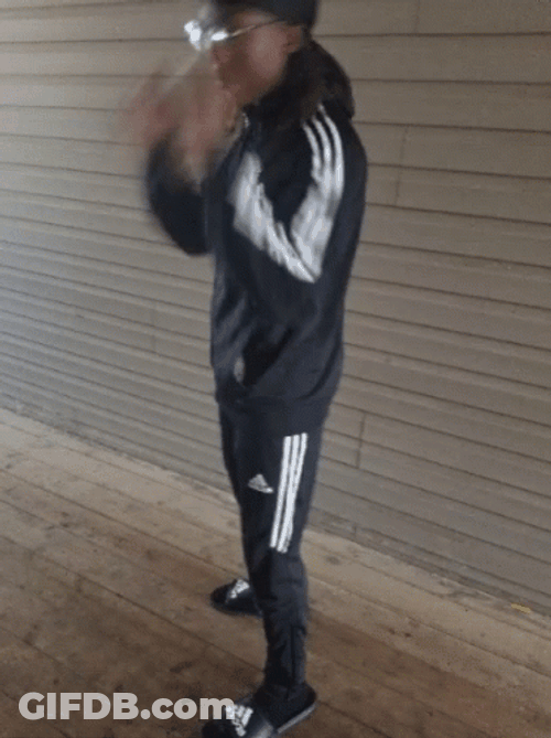 Guy Holding Glasses Wearing Black Adidas Suit GIF