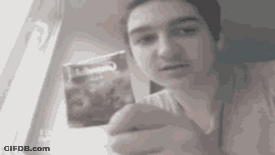 Guy Holding Pack Of Tea Bags GIF
