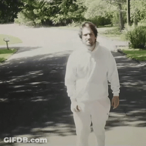 Guy In All White Outfit Walking Backwards GIF