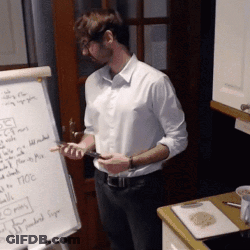 Guy In White Reading While Tapping Knife GIF