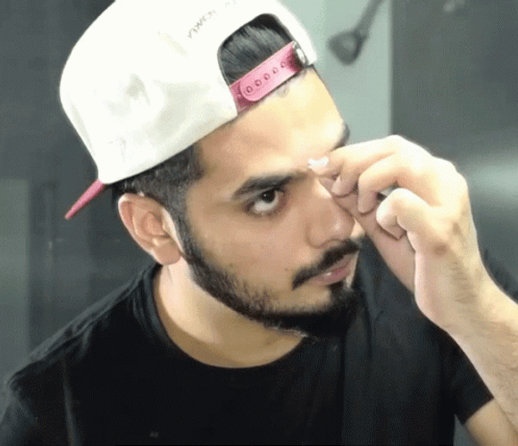 Guy Looks Mirror Pinch Scab GIF