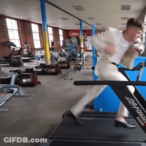Guy On A Suit Running On Treadmill GIF