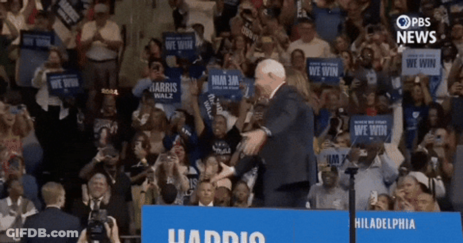 Guy Runs Hugs Harris Walz GIF