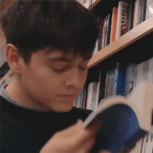 Guy Smelling A Book GIF