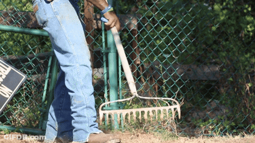 Guy Spreading Mulch On The Ground GIF