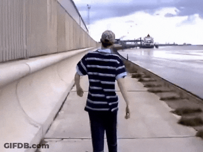 Guy Walking On A Promenade GIF