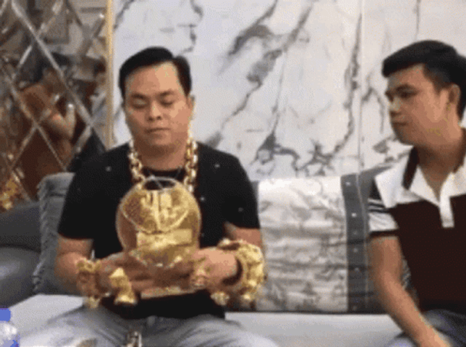 Guy Wearing Gold Cap And Jewelry GIF