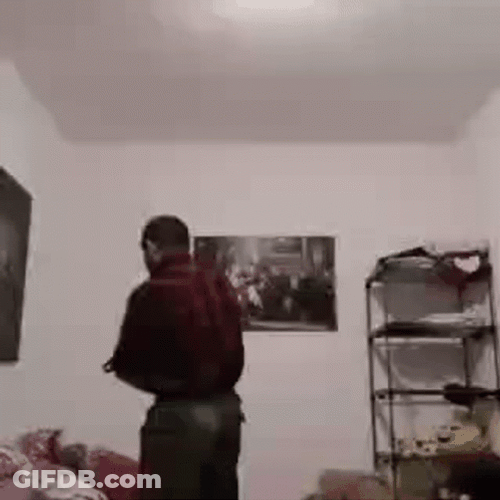 Guy Yanking Belt Hitting Screen GIF