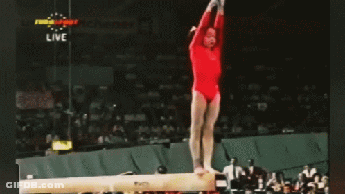Gymnast Performing Trick On Balance Beam GIF
