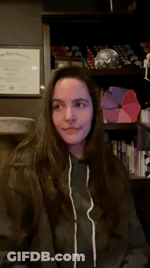 Hair Tuck Woman Wearing Hoodie GIF