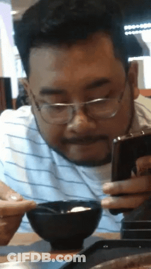 Hakuna Matata Asian Guy Eating While On Phone GIF