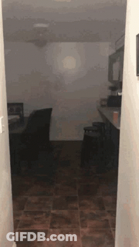 Hallway Leading To Dark Room With Ceiling Fan GIF