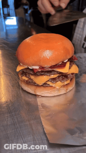 Hamburger With Cheese And Bacon On Metal Surface GIF
