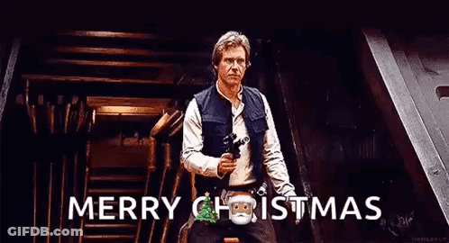 Han Solo Is Holding A Gun And Saying Merry Christmas While Standing In A Room . GIF